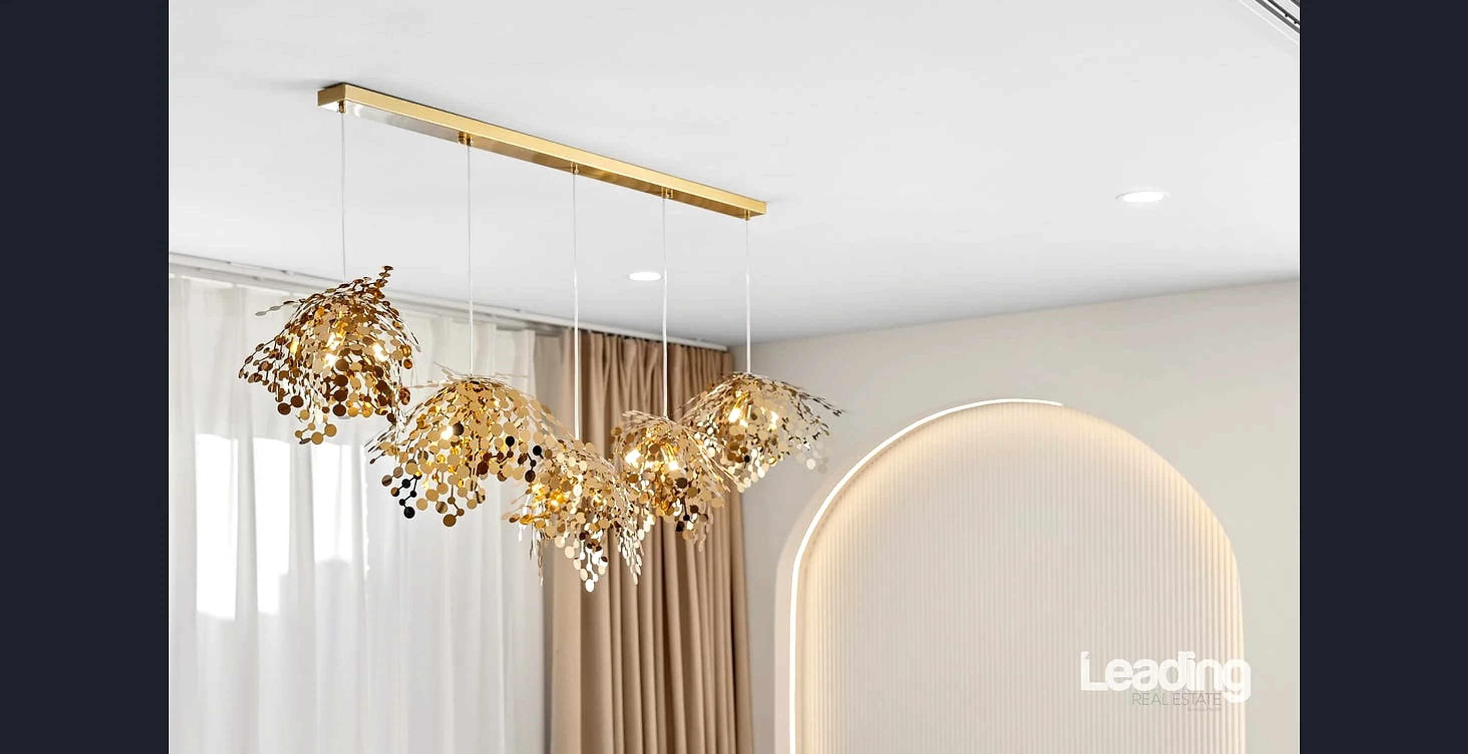Close view of the sculptural gold pendant and the LED-lit feature arch